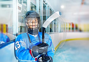 Young hockey player in protective equipment