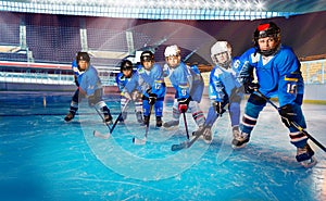 Young hockey players ready for puck on ice rink