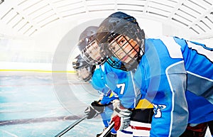 Young hockey players standing in line on ice rink