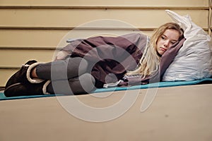Homeless young teen taking shelter photo