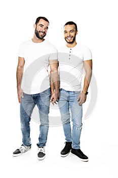 Young homosexuals gay couple love each other on a white background.