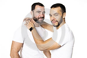 Young homosexuals gay couple love each other on a white background.