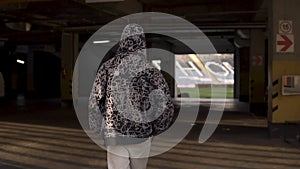 Young hooligan streetstyle guy going on the football stadium at the evening at autumn