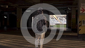 Young hooligan streetstyle guy going on the football stadium at the evening at autumn