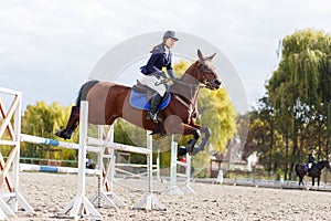 Young horse rider girl on equestrian competition