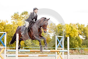 Young horse rider girl on equestrian competition