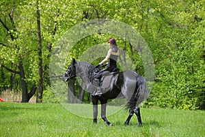 Young horseback rider having pleasure in forest