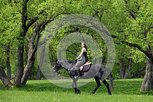 Young horseback rider having pleasure in forest