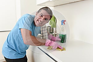 Young house cleaner man washing and cleaning the kitchen tired in stress