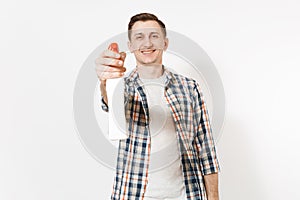 Young housekeeper man in checkered shirt holding white blank empty cleaning spray bottle with cleaner liquid isolated on