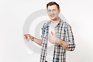 Young housekeeper man in checkered shirt holding white blank empty cleaning spray bottle with cleaner liquid isolated on