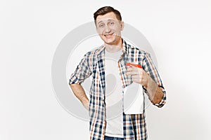 Young housekeeper man in checkered shirt holding white blank empty cleaning spray bottle with cleaner liquid isolated on