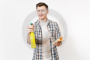 Young housekeeper man holding cleaning rag, white blank empty spray bottle with cleaner liquid isolated on white