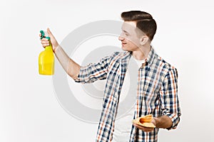 Young housekeeper man holding cleaning rag, white blank empty spray bottle with cleaner liquid isolated on white