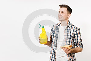 Young housekeeper man holding cleaning rag, white blank empty spray bottle with cleaner liquid isolated on white