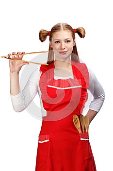 Young housewife in bright red apron with funny ponytails holding