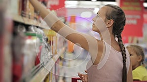 Young housewife chooses goods in the supermarket