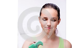 The young housewife in cleaning concept