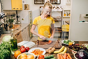 Young housewife cooking on the kitchen, eco food