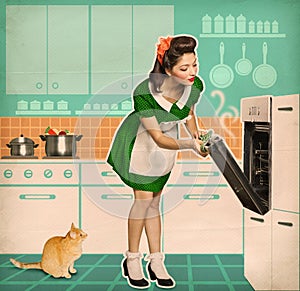 Young housewife cooking in an oven.Retro kitchen room interior