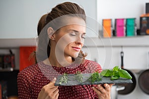 Young housewife enjoying fresh spices herbs