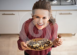 Young housewife showing mushrooms