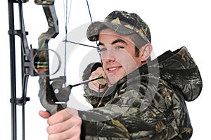 Young hunter with bow aiming