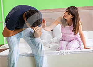 Young husband having problems with health in bedroom