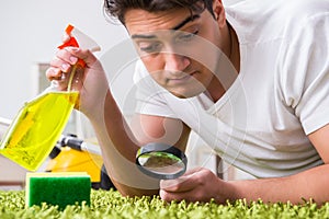 The young husband man cleaning floor at home