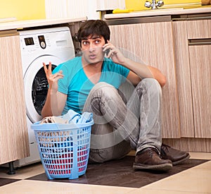 Young husband man doing laundry at home