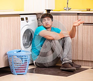 Young husband man doing laundry at home