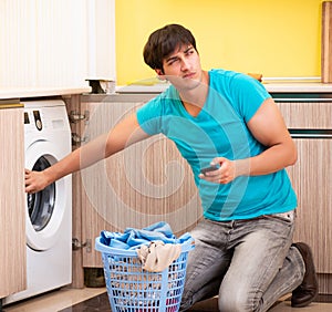 Young husband man doing laundry at home