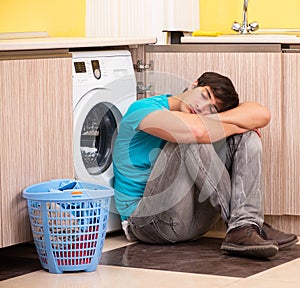 Young husband man doing laundry at home