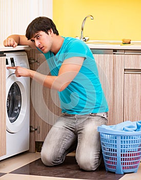 Young husband man doing laundry at home