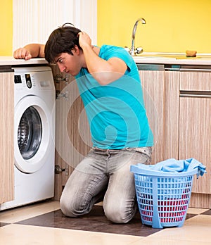 Young husband man doing laundry at home