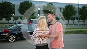 Young husband, man is giving car gift wife, girlfriend. Extremely happy woman