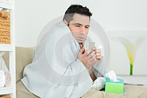 young ill man with coffee mug