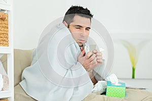 young ill man lying in bed at home