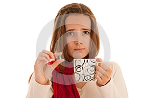 Young ill woman taking an antibiotic pill isolated over white background