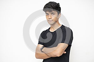 Young Independent boy standing on a white wall, arms folded, startup and business
