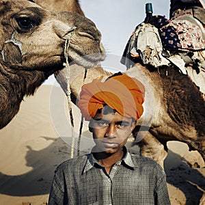 Young Indian Boy with Camels Desert Concept