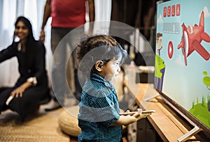 Young Indian boy watching television photo