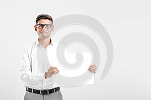 Young Indian business executive showing blank sign board over white background