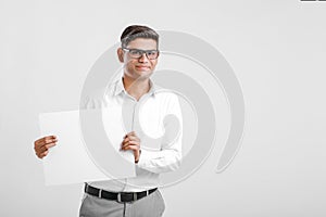 Young Indian business executive showing blank sign board over white background