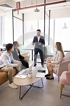 Young Indian business team leader man conducting meeting with employees