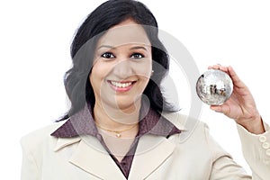Young Indian business woman holding puzzle globe