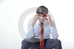 Young indian businessman with headache over white background