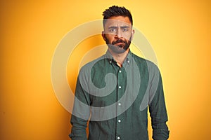 Young indian businessman wearing elegant shirt standing over isolated white background depressed and worry for distress, crying