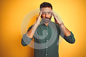 Young indian businessman wearing elegant shirt standing over isolated white background with hand on head for pain in head because