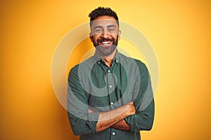 Young indian businessman wearing elegant shirt standing over isolated white background happy face smiling with crossed arms